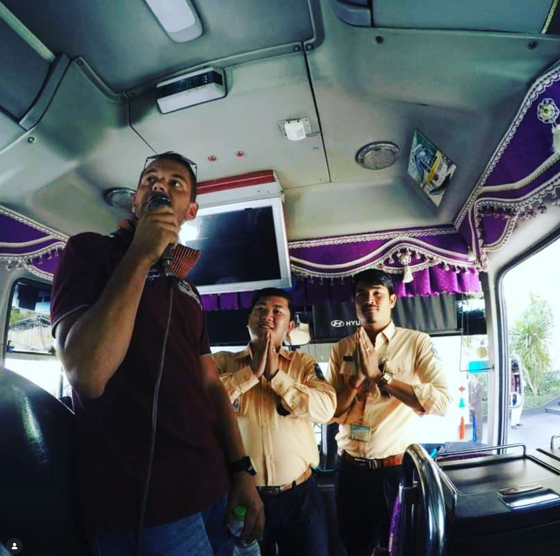 Jan Van Den Wyngaert — addressing the group on a bus during an incentive trip